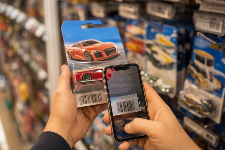 Scanning a Hot Wheels barcode at a store peg wall